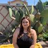 photo of yesenia de alba sitting in front of cactus