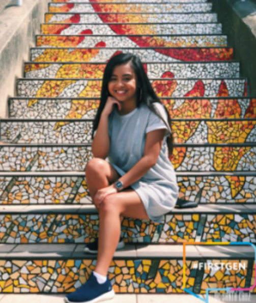 photo of anabell vidanes smiling and sitting on colorful, tiled staircase