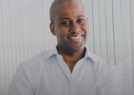 photo of darrick smith smiling in white collar shirt