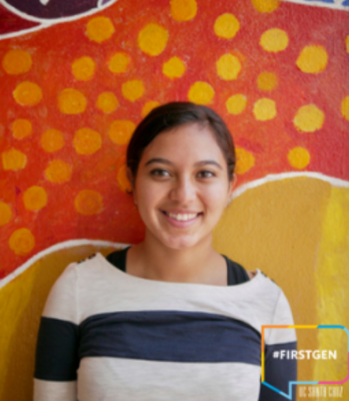 photo of eyra gonzalez smiling in striped blouse with colorful background