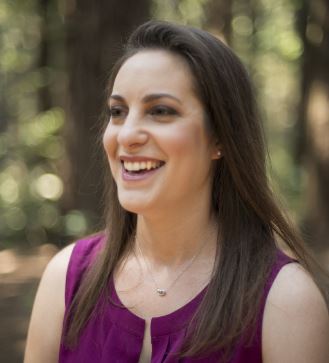 photo of shelly meron smiling in a purple blouse