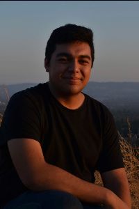 photo of walter arevalo sitting in front of ocean